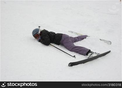 Skier lying down in snow