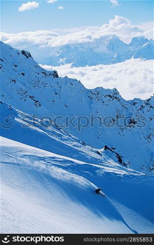 Skier on mountain slope elevated view