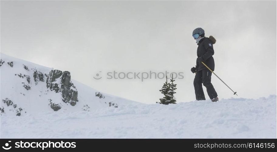 Skier on snow covered mountain, Whistler, British Columbia, Canada
