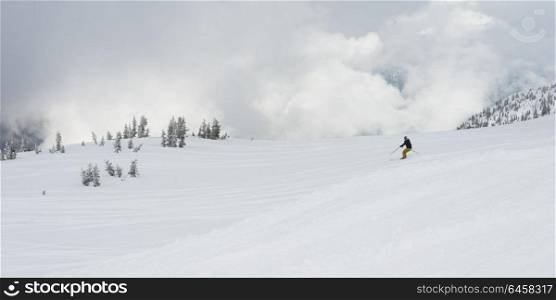 Skier on snowy mountain, Whistler, British Columbia, Canada