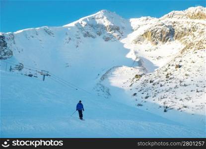 Skier on the mountain slope. Winter landscape.