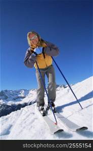 Skier standing on hill smiling