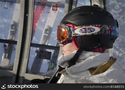 Skier with ski goggles and helmet on the chairlift, Kicking Horse Mountain Resort, Golden, British Columbia, Canada