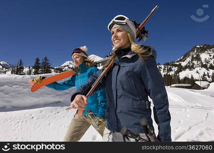 Skiers Carrying Skis on Mountain