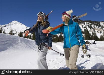 Skiers Carrying Skis on Mountain