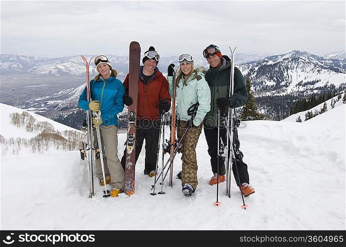Skiers Holding Skis on Mountain
