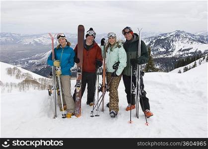 Skiers Holding Skis on Mountain