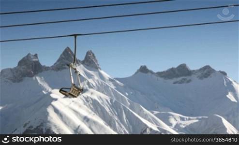 skiers on chair lift in Le Corbier, French Alps