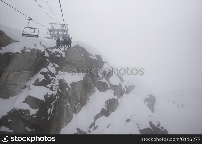Skiers on ski lift at ski resort, Whistler, British Columbia, Canada