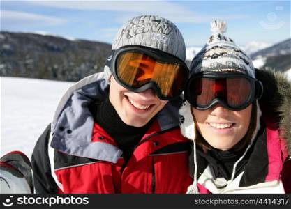 Skiing couple laying in the snow
