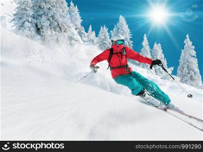Skiing. Jumping skier. Extreme winter sports.. Skier skiing downhill in high mountains