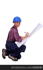 Skilled construction worker amending a blueprint
