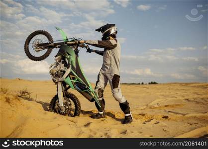 Skilled professional moto rider making stunt on motorbike. Biker doing difficult and dangerous trick. Skilled moto rider making stunt on motorbike