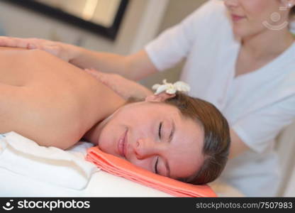 skillful beautician massaging female body