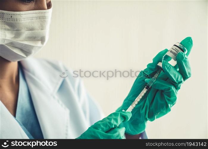 Skillful doctor prepare vaccine proficiently before injection . Covid 19 and coronavirus vaccination center service concept .. Skillful doctor prepare vaccine proficiently before injection