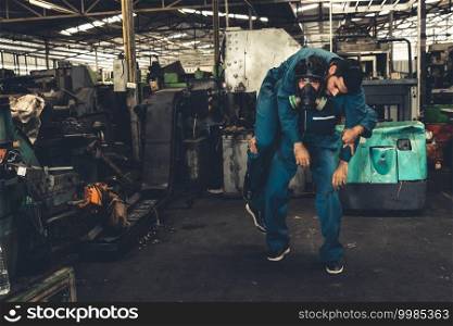 Skillful factory worker rescue his teammate out of poisonous gas leakage . Industry and engineering people accident and safety concept .. Skillful factory worker rescue his teammate out of poisonous gas leakage
