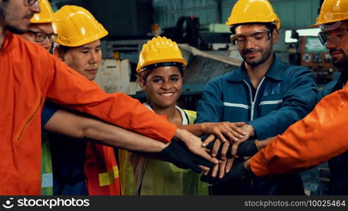 Skillful worker stand together showing teamwork in the factory . Industrial people and manufacturing labor concept .