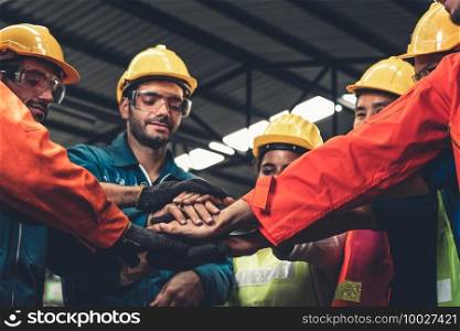 Skillful worker stand together showing teamwork in the factory . Industrial people and manufacturing labor concept .. Skillful worker stand together showing teamwork in the factory .