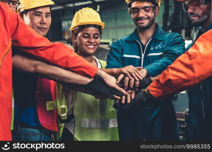 Skillful worker stand together showing teamwork in the factory . Industrial people and manufacturing labor concept .. Skillful worker stand together showing teamwork in the factory .