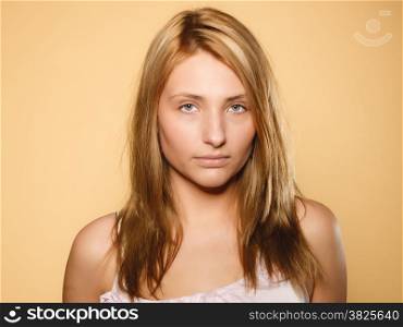 Skin care. Attractive blonde woman with no makeup, fresh face with natural make up, brown background