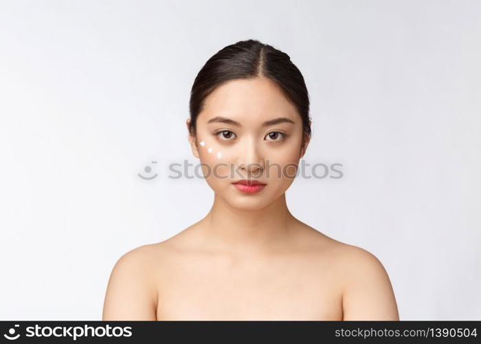 Skin care beauty woman. Beauty woman smiling applying cream. Beauty portrait of beautiful Asian Caucasian female model isolated on white. Skin care beauty woman. Beauty woman smiling applying cream. Beauty portrait of beautiful Asian Caucasian female model isolated on white.