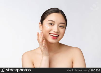 Skin care beauty woman. Beauty woman smiling applying cream. Beauty portrait of beautiful Asian Caucasian female model isolated on white. Skin care beauty woman. Beauty woman smiling applying cream. Beauty portrait of beautiful Asian Caucasian female model isolated on white.