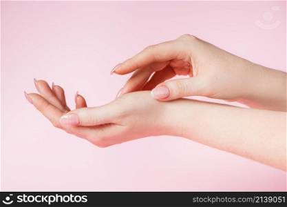 Skin care concept. Beautiful female hands on a pink background. Place for text. Beautiful Female Hands on Pink Background