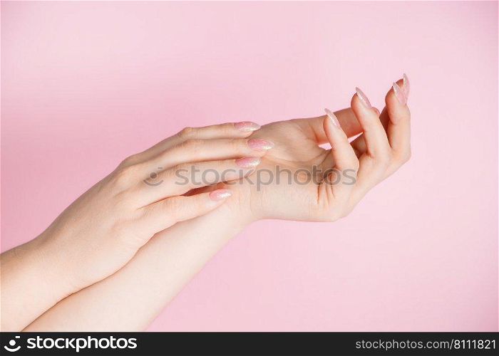 Skin care concept. Beautiful female hands on a pink background. Place for text. Skin care concept. Beautiful female hands on pink background. Place for text.