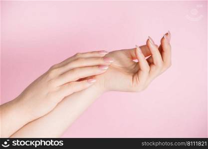 Skin care concept. Beautiful female hands on a pink background. Place for text. Skin care concept. Beautiful female hands on pink background. Place for text.