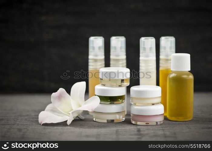 Skin care products. Various jars and bottles of skin care products with orchid flower