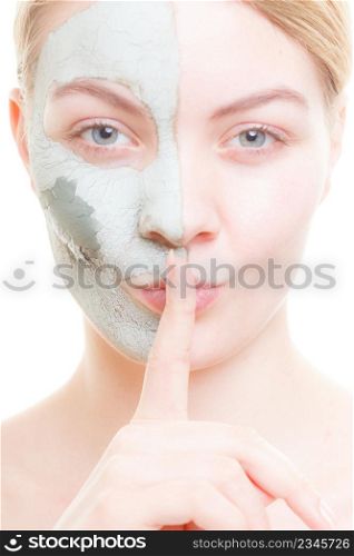Skin care, secrets, cosmetology concept. Woman having mud algae mask on her face, making silence gesture. Woman having mud green mask on her face