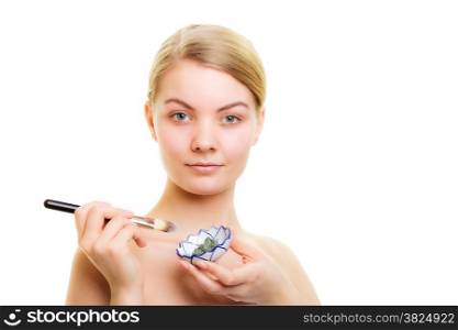 Skin care. Woman applying with brush clay mud mask on face isolated on white. Girl taking care of dry complexion. Beauty treatment.