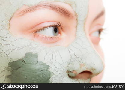 Skin care. Woman in clay mud mask on face isolated on white. Girl taking care of dry complexion. Beauty treatment.