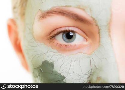 Skin care. Woman in clay mud mask on face isolated on white. Girl taking care of dry complexion. Beauty treatment.