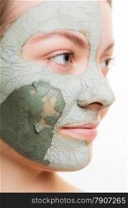 Skin care. Woman in clay mud mask on face isolated on white. Girl taking care of dry complexion. Beauty treatment.