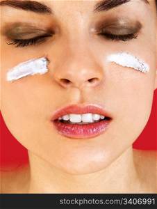 Skin care woman putting face cream touching under eyes