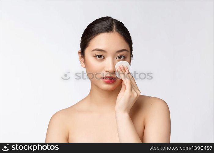 skin care woman removing face makeup with cotton swab pad - skin care concept. Facial closeup of beautiful mixed race model with perfect skin. skin care woman removing face makeup with cotton swab pad - skin care concept. Facial closeup of beautiful mixed race model with perfect skin.