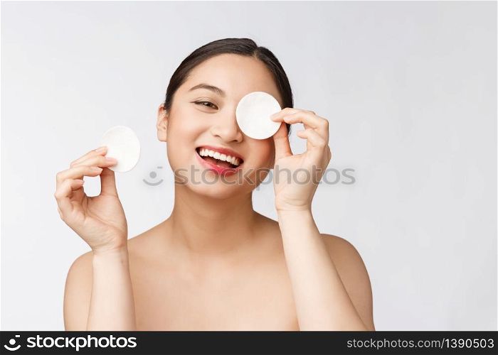 skin care woman removing face makeup with cotton swab pad - skin care concept. Facial closeup of beautiful mixed race model with perfect skin. skin care woman removing face makeup with cotton swab pad - skin care concept. Facial closeup of beautiful mixed race model with perfect skin.