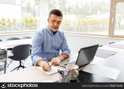 skin health, remote job and business concept - middle-aged man with vitiligo on his face and laptop computer working at home office. man with vitiligo working at home office