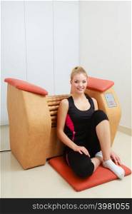 Skincare, bodycare, wellness concept. Woman relaxing after getting rid of cellulite on big roll machine. Healthy massage treatment. Woman relaxing after cellulite treatment on machine