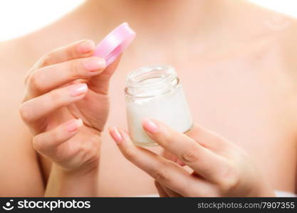 Skincare. Closeup of female hands. Young woman girl taking care of her dry complexion applying moisturizing cream isolated. Beauty treatment.