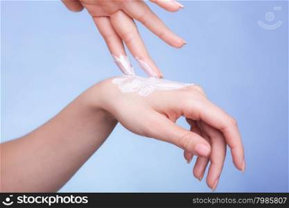 Skincare. Closeup of female hands. Young woman girl taking care of her dry hands palms applying moisturizing cream. Beauty treatment.