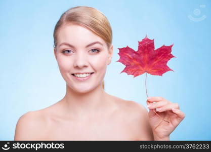 Skincare habits. Portrait of young woman with leaf as symbol of red capillary skin on blue. Face of girl taking care of her dry complexion. Studio shot.