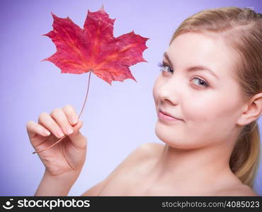 Skincare habits. Portrait of young woman with leaf as symbol of red capillary skin on violet. Face of girl taking care of her dry complexion. Studio shot.