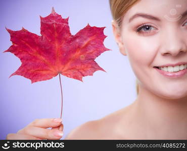 Skincare habits. Portrait of young woman with leaf as symbol of red capillary skin on violet. Face of girl taking care of her dry complexion. Studio shot.