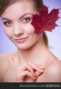 Skincare habits. Portrait of young woman with leaf as symbol of red capillary skin on violet. Face of girl taking care of her dry complexion. Studio shot.