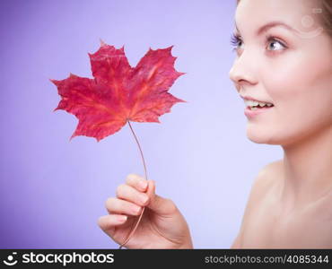 Skincare habits. Portrait of young woman with leaf as symbol of red capillary skin on violet. Face of girl taking care of her dry complexion. Studio shot.