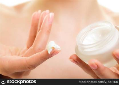 Skincare. Woman taking care of her dry complexion. Moisturizing cream in female hands isolated. Beauty treatment.