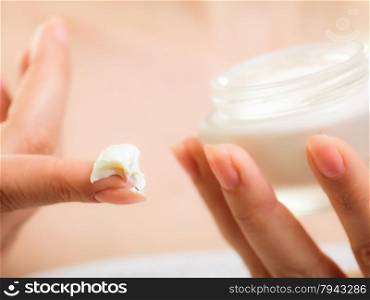 Skincare. Woman taking care of her dry complexion. Moisturizing cream in female hands isolated. Beauty treatment.
