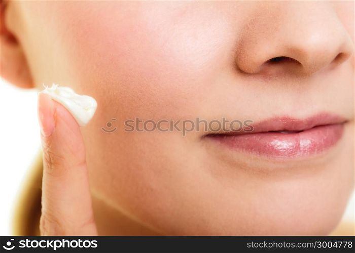 Skincare. Woman taking care of her dry complexion. Moisturizing cream on female hand isolated. Beauty treatment.